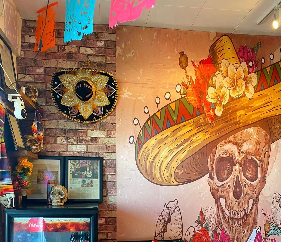 Don Taco Calgary interior with Day of the Dead mural, sombrero and papel picado