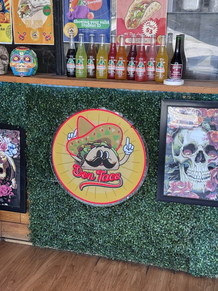 Don Taco logo sign with Jarritos soda display and sugar skull decor in Calgary