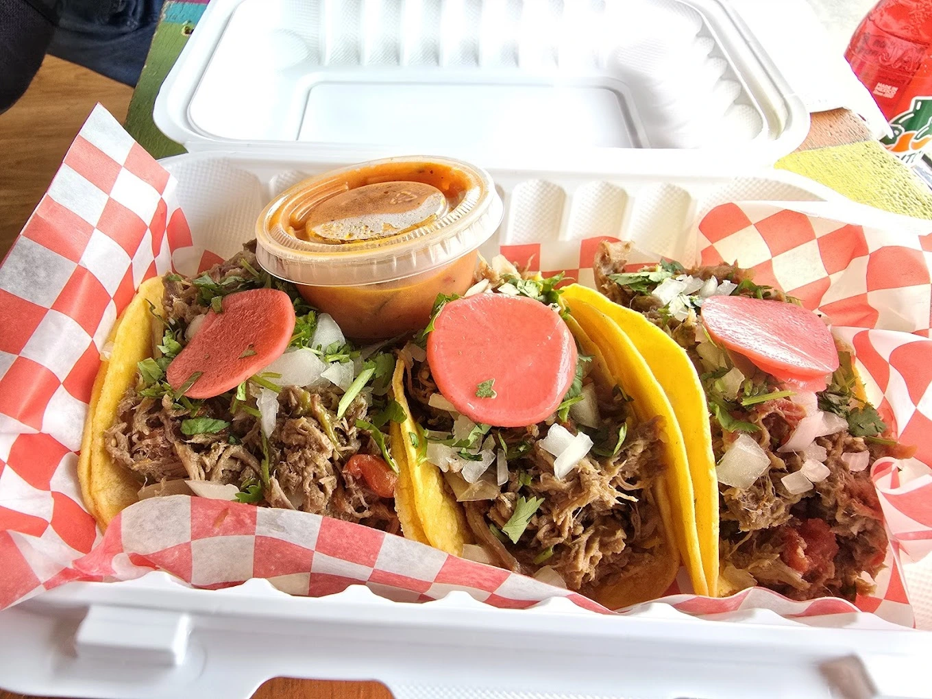 Pork carnitas tacos takeout box with salsa at Don Taco Calgary